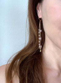 Rose quartz heart drop earrings worn, featuring layered gold filled chains and a delicate heart charm.