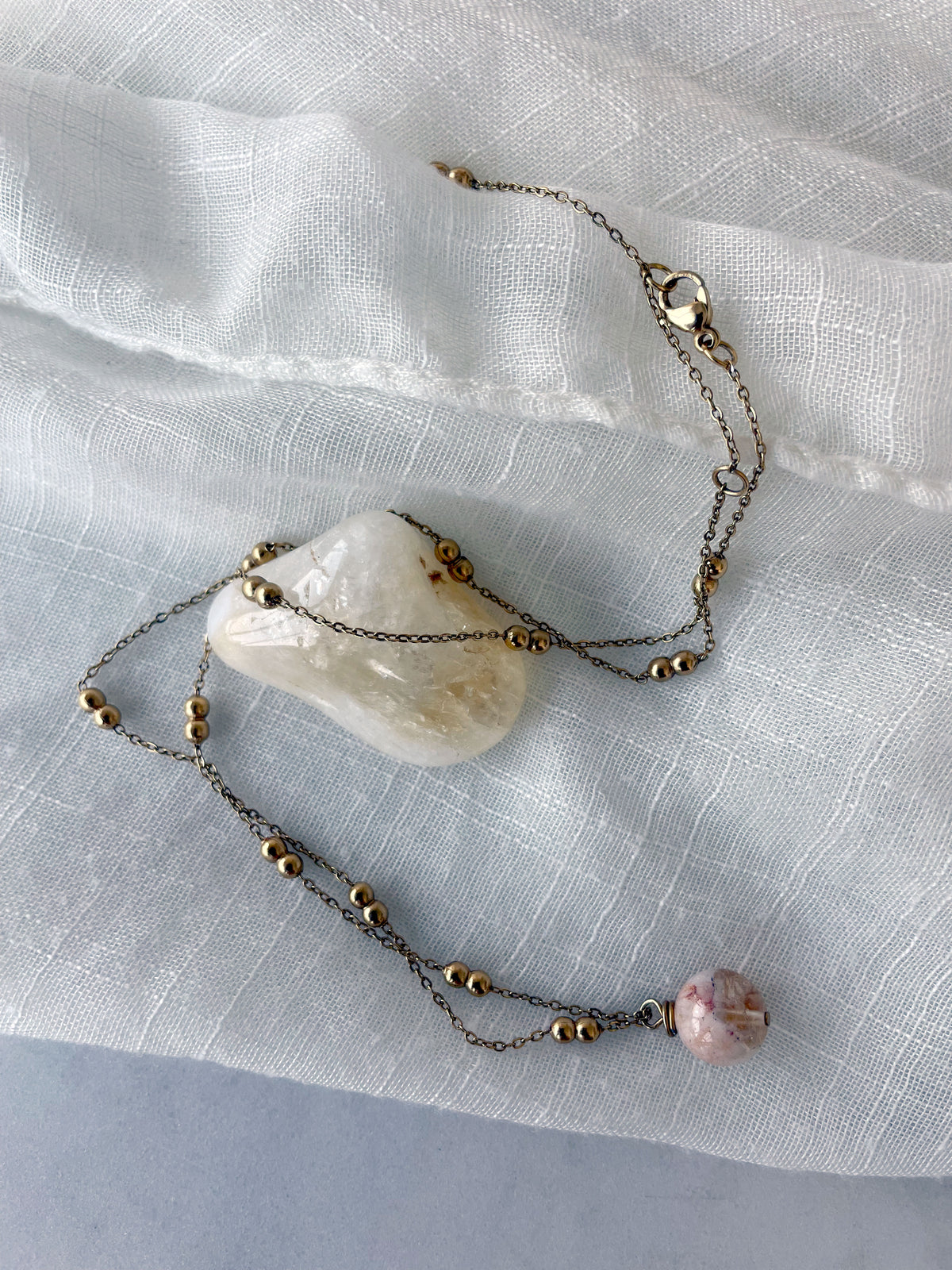 A gold plated necklace with a 10mm Citrine bead on a delicate chain with 3mm Ball and 1mm Curb Chain.