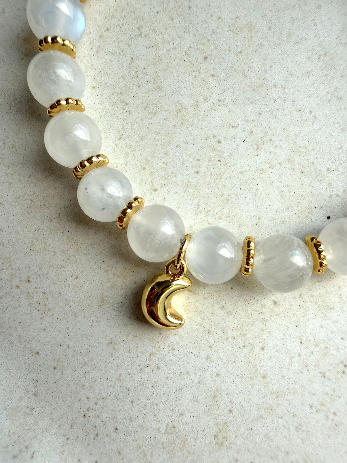 Close-up of the Lunar Moonstone Bracelet with genuine Moonstone beads, gold-plated accents, and a polished crescent moon charm.