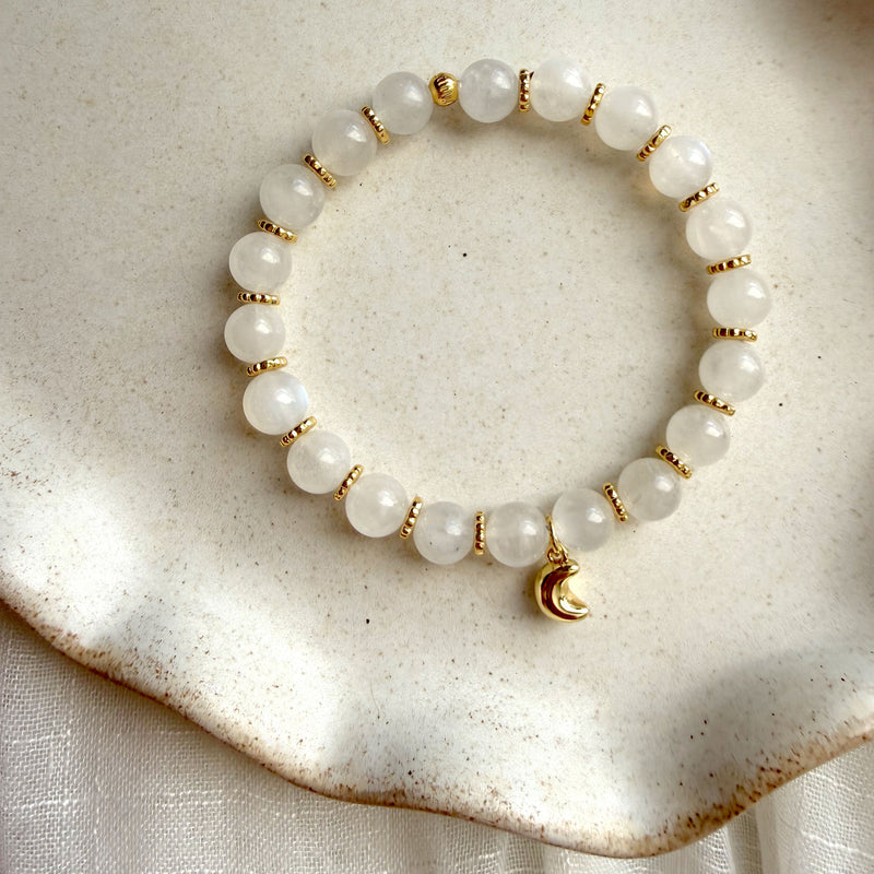 Lunar Moonstone Bracelet featuring genuine Moonstone gemstones, gold-plated spacer beads, and a crescent moon charm, handcrafted for everyday wear.