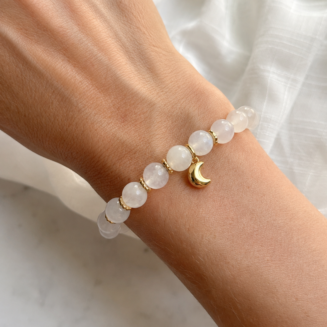 Lunar Moonstone Bracelet worn on the wrist, featuring genuine Moonstone gemstones, gold-plated spacer beads, and a delicate crescent moon charm.