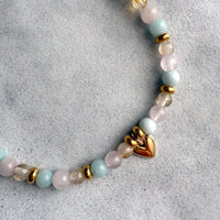 Handcrafted Sisterhood Bracelet with citrine, rose quartz, amazonite, and gold-filled heart charm on a neutral background.
